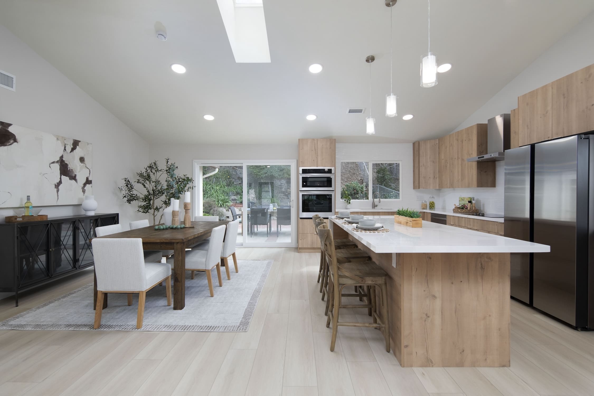 ADU kitchen and open plan dining room remodel with large island and wood cabinets — San Diego CA