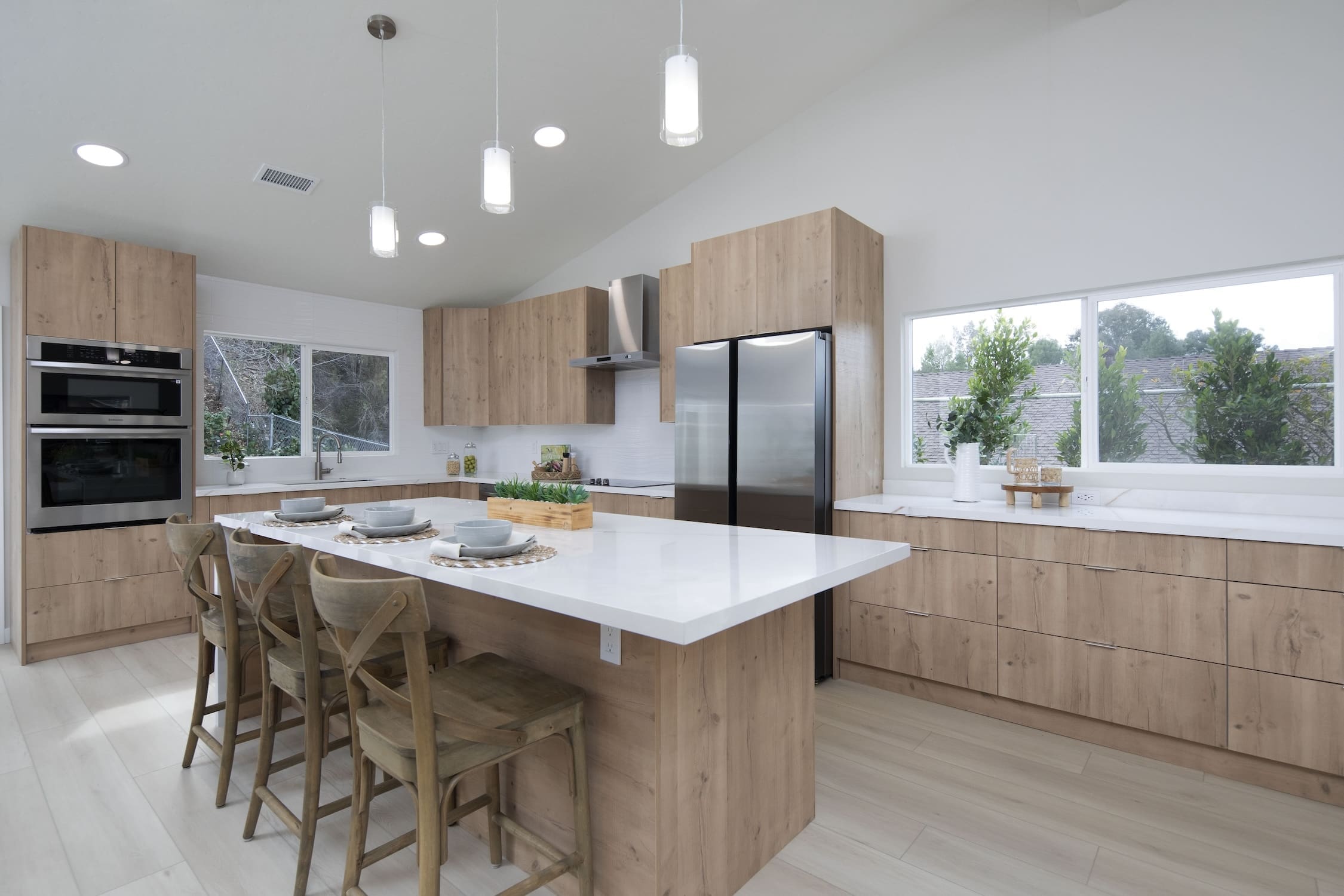 a kitchen with a large island and chairs