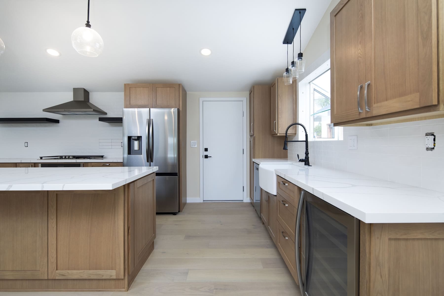 a kitchen with wooden cabinets and white countertops