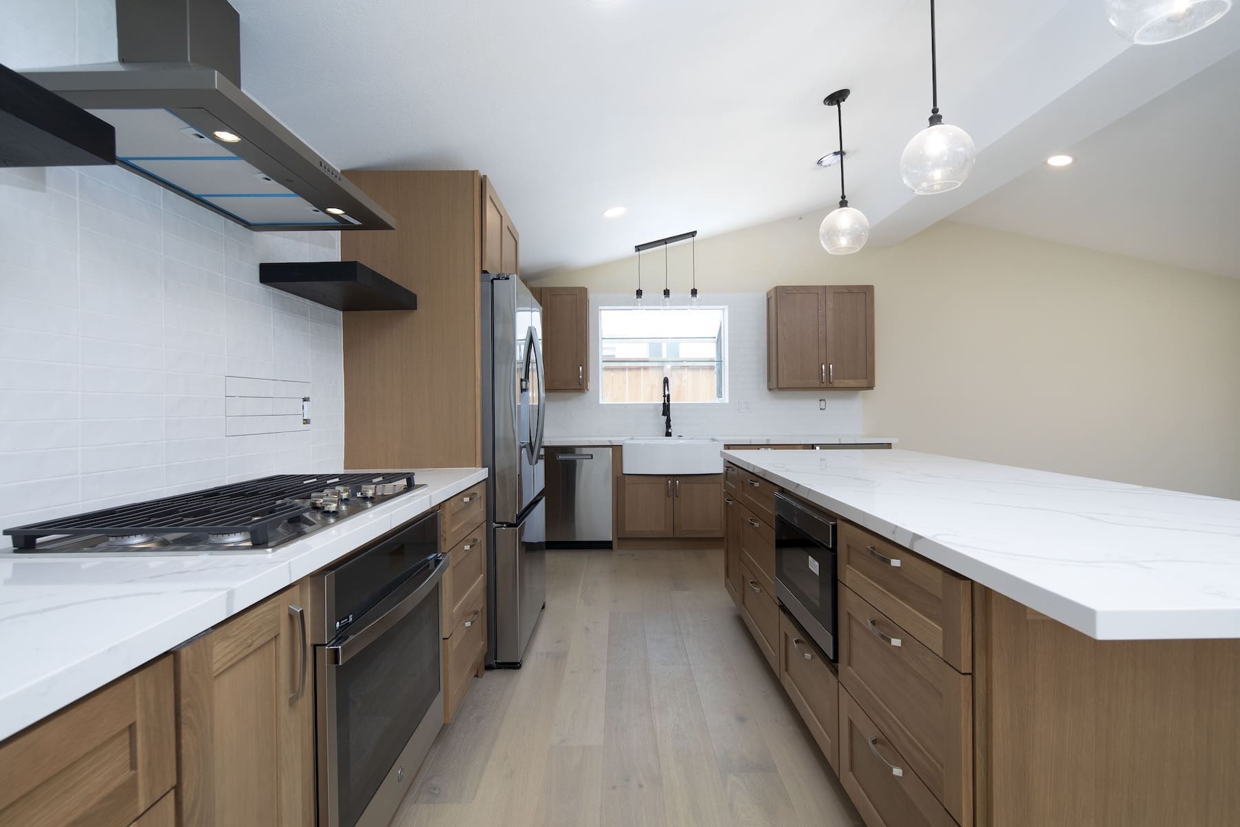 a kitchen with wood cabinets and white counter tops