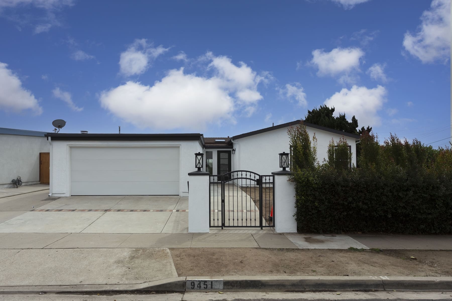 a house with a gate and a driveway