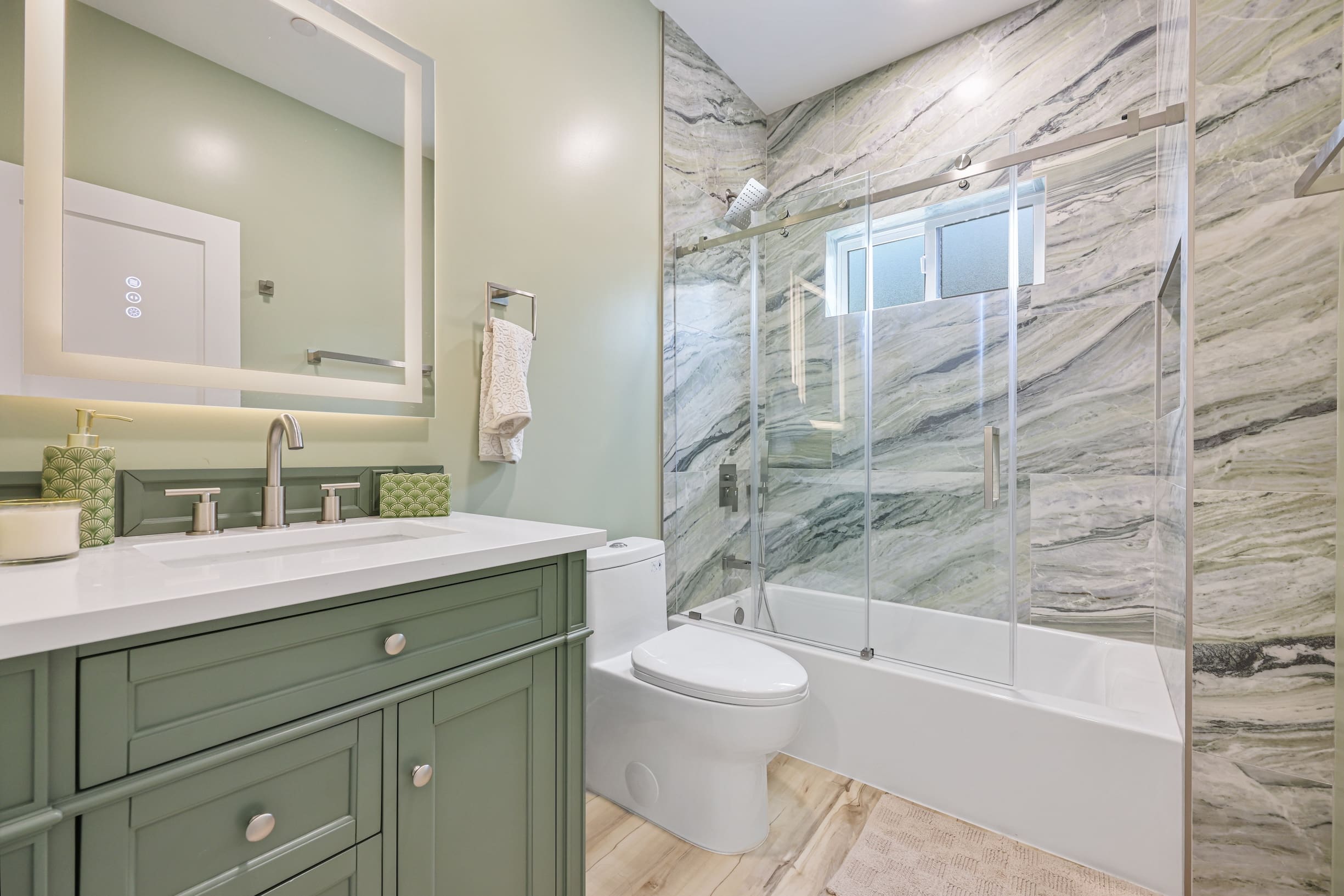Modern bathroom with green accents.